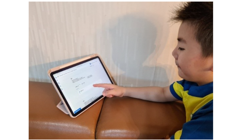 A boy using an iPad to do an online package